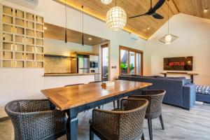 a kitchen and living room with a wooden table and chairs at Villa Domus A1 in Sanur