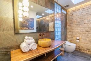 a bathroom with a wooden sink and a toilet at Villa Domus A1 in Sanur +25 photos