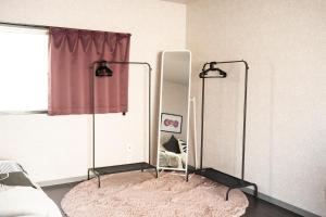 a bedroom with a mirror and a bed at Vinyl Stay - spacious local apartment in Osaka