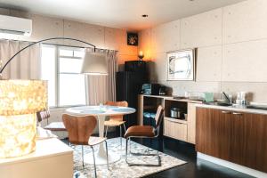 a kitchen with a table and chairs in a room at Vinyl Stay - spacious local apartment in Osaka