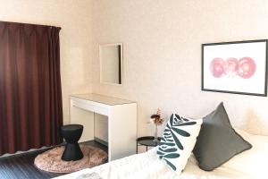 a living room with a bed and a fireplace at Vinyl Stay - spacious local apartment in Osaka
