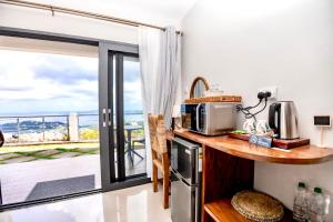 CharlotteにあるHammock Suite Shack-Shack by ZenBreakのキッチン(電子レンジ付きカウンター、バルコニー付)