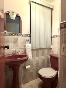 a bathroom with a toilet and a sink at Casa Sierravista in Zacatlán +12 photos
