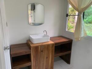 a bathroom with a white sink and a window at Baan Phuean Koh Kood in Ko Kood