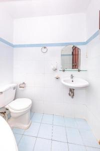 a white bathroom with a toilet and a sink at Minh Cat Hotel in Nha Trang
