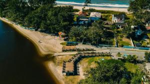 an aerial view of a beach next to the water at Hotel Vila ÁguaMar in Itapoa +17 photos