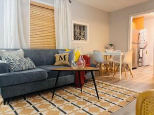 a living room with a blue couch and a table at Stylish Stay in the Heart of Decatur King Bed in Decatur +45 photos
