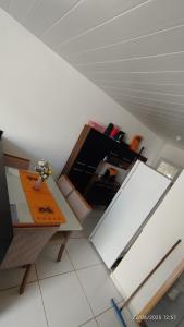 a kitchen with a table and a white refrigerator at Casa aconchegante em Garanhuns in Garanhuns +7 photos