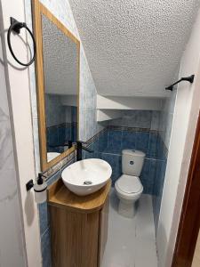 a bathroom with a sink and a toilet at Casa Alma Hospedaje in Mocoa