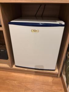 a white freezer in a drawer in a cabinet at Hotel La'i ローレル Adult only in Tokyo