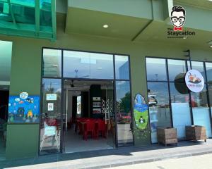 a store front with glass doors and a table in it at Staycation Homestay 77 D'Millenia near UNIMAS in Kuching