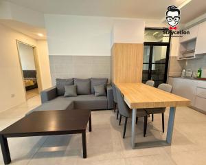 a living room with a couch and a table at Staycation Homestay 77 D'Millenia near UNIMAS in Kuching