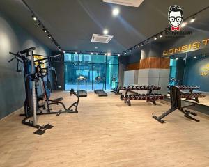 a gym with several treadmills and benches in a room at Staycation Homestay 77 D'Millenia near UNIMAS in Kuching