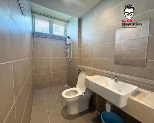 a bathroom with a toilet and a sink at Staycation Homestay 77 D'Millenia near UNIMAS in Kuching +9 photos