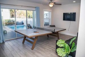 a ping pong table in the middle of a living room at Beach Retreat Complex w Pool - Sleeps 25 in Jacksonville Beach