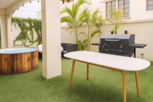 a ping pong table and a grill in a courtyard at Private Villa in Cabo with Garden, Hot Tub & Medano Beach just 10 min away in Cabo San Lucas +31 photos