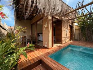 a backyard with a swimming pool and a house at Naim Milagres in São Miguel dos Milagres