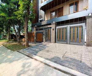 a building with a gate in front of it at Cozy and Tranquil nest with wifi and homely care in Greater Noida