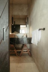 a bathroom with a sink and a counter with a mirror at The Iggy Hotel Seseh Studio 1 Sauna, Ice Bath in Cemagi