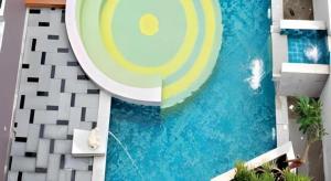 a room with a mural of a pool at The Sez Hotel Bangsaen in Ban Laem Thaen
