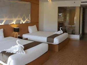 a hotel room with two beds and a bathroom at The Vista Hotel By Satit Group in Sadao +150 photos