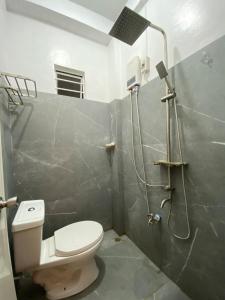 a bathroom with a toilet and a shower in it at Isle Be Back Catanduanes Staycation - Cavinitan in Virac