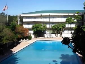 an empty swimming pool in front of a building at Magnuson Grand Conference Hotel in Cypress Gardens
