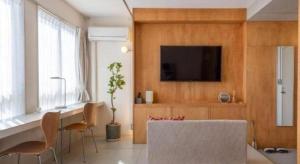 a living room with a tv and a table and chairs at Nest West Garden Tosa Hotel in Kuroshio