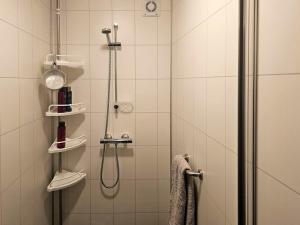 a bathroom with a shower with a glass door at Charming Farm Stay On Averøy Island in Lyngstad +17 photos