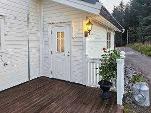 a white garage with a door on a wooden deck at Charming Farm Stay On Averøy Island in Lyngstad