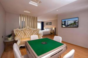 a room with a pool table in a hotel room at danfeng kelly hotel in Dapeng