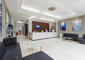 a lobby with couches and a counter in a building at City Comfort Inn Guangzhou Tianhe District Tangxia Exhibition Center in Guangzhou