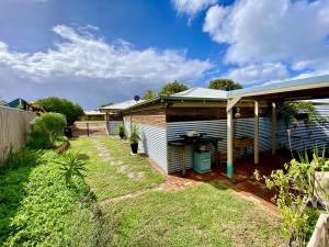 aussie house with a garden in front of it at Gantheaume Getaway in Kalbarri