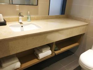 a bathroom with a sink and a toilet at City Comfort Inn Jiangxia Wuchang University of Technology in Wuhan