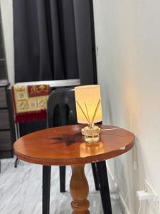 a small wooden table with a box on top of it at D Bukit homestay in Ketereh