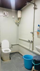 a bathroom with a toilet and a sink at Aasa Farmhouse in Hyderabad