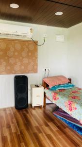 a small bedroom with a bed and a fan at Aasa Farmhouse in Hyderabad +14 photos