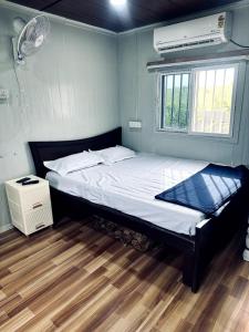 a bedroom with a bed and a window at Aasa Farmhouse in Hyderabad