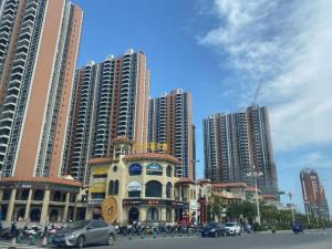 a building in a city with tall buildings at Borrman Hotel Zhanjiang Wuchuan Jinsha Plaza in Xindi