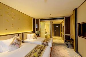a hotel room with two beds and a television at Dahe Jinjiang Hotel in Zhengzhou +161 photos