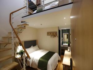 a bedroom with a bed and a spiral staircase at Green Tree Inn Express Beijing Xicheng District Dazhalan in Beijing +176 photos