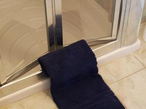 a black tie sitting next to a glass door at Rivotorto Retreat House in Birkirkara