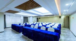 a large room with blue tables and white chairs at Borrman Hotel Guilin Elephant Hill Park Li Lake in Guilin