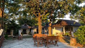 a house with a table and chairs in front of it at A-Thip House in Pai