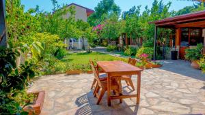 a wooden table and chairs on a patio at Dalyan Pension in Dalyan