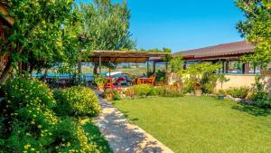 a garden with a pavilion in the back of a house at Dalyan Pension in Dalyan
