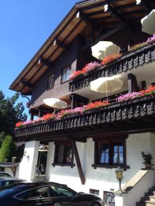 a building with flower boxes on the side of it at Kur- und Ferienhotel Haser in Oberstaufen