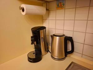 a coffee maker sitting on a counter in a kitchen at Gemütliches Apartment in Giengen an der Brenz +2 photos