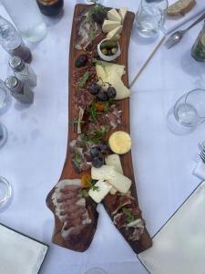 a wooden plate of food on a table at Maisonnette privé bord de mer Poggio mezzana in Poggio-Mezzana +14 photos