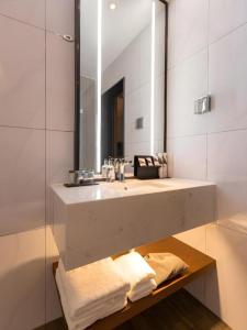 a bathroom with a sink and a mirror at Borrman Hotel Guilin Railway Station Two Rivers and Four Lakes in Guilin